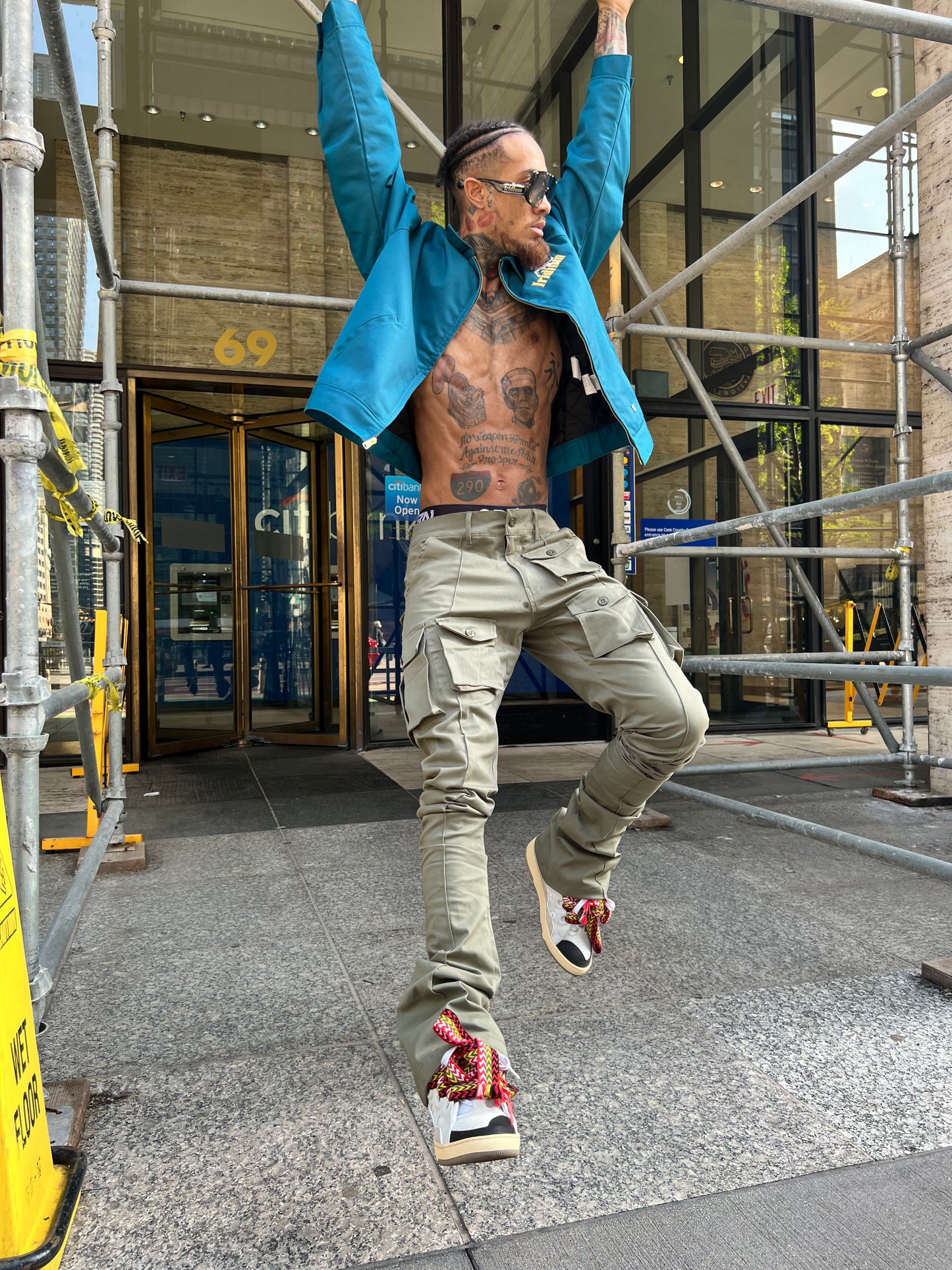 Model in motion wearing Green Stacked Cargo Pants in an outdoor city setting