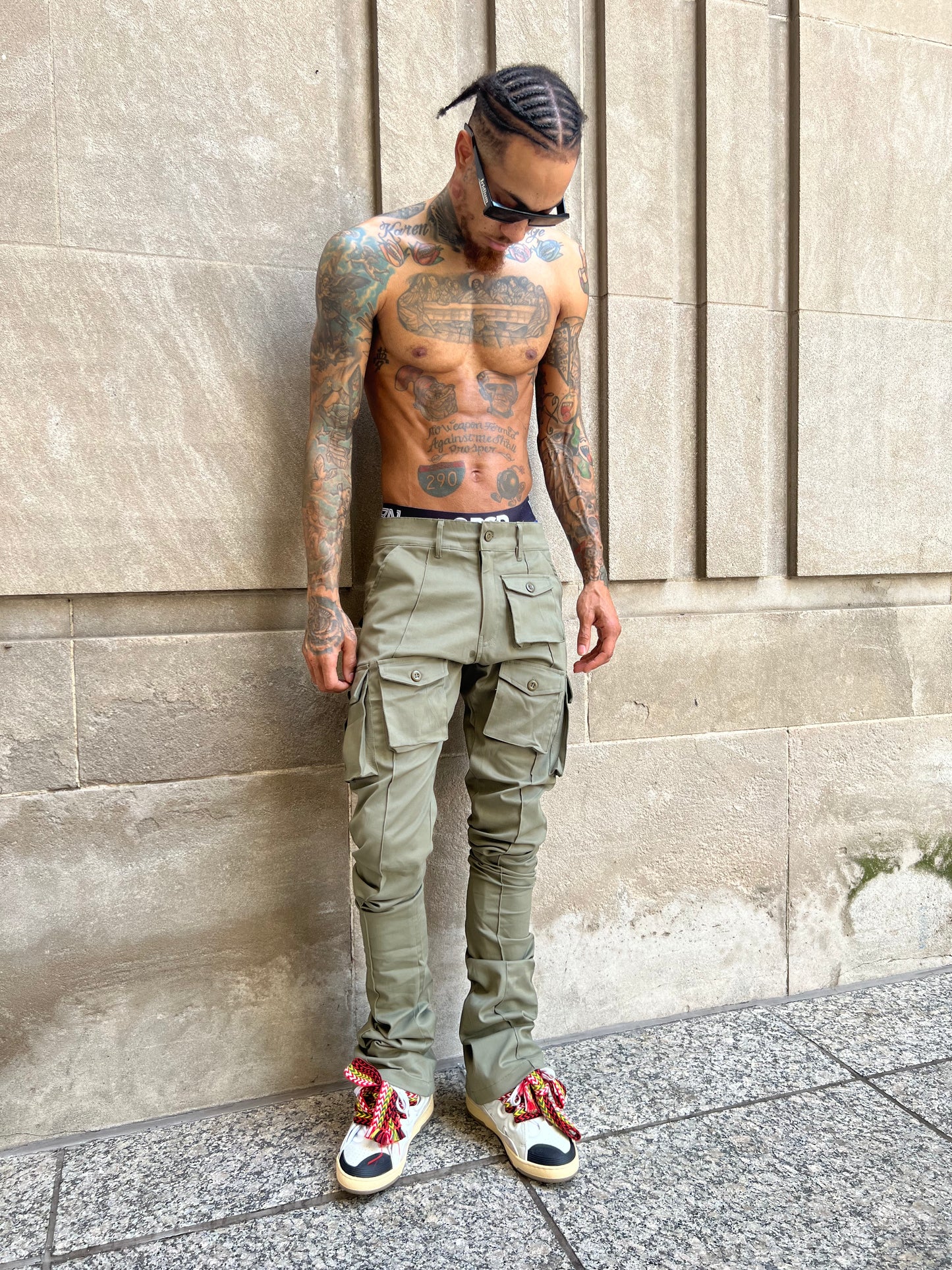 Model wearing Iridium Green Stacked Cargo Pants in a full front view outdoors