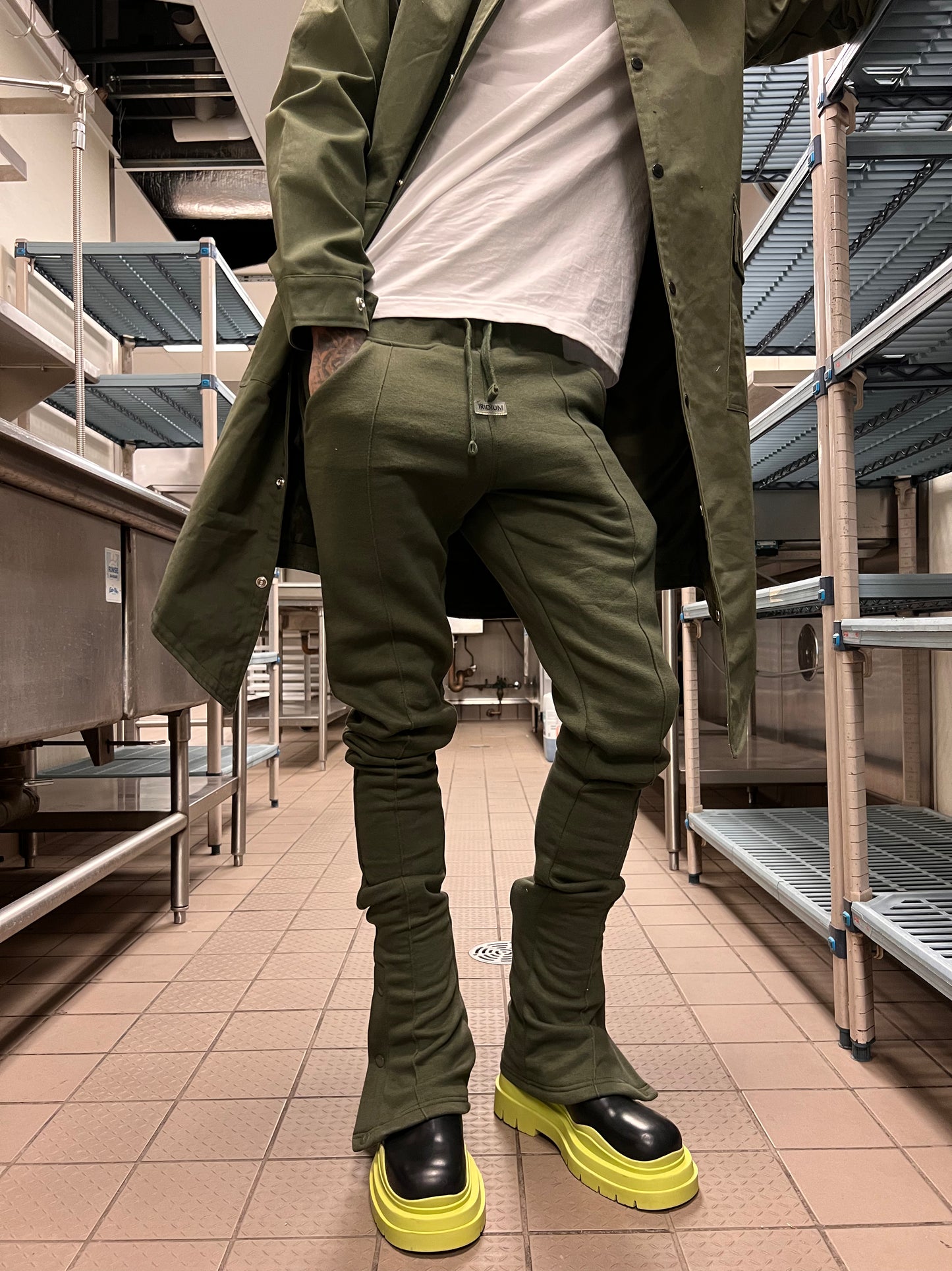Model wearing Iridium Green Stacked Joggers with an olive jacket